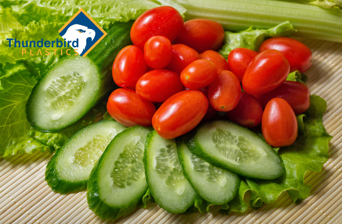 An image of cucumbers and tomatoes. Tags: agricultural harvesting containers, greenhouse automation, greenhouse harvesting bins, produce lugs, harvest totes, plastic farm bins, automated farming equipment, injection moulded containers, stackable harvest crates, greenhouse farming Canada, cucumber totes, bulk harvesting bins, sustainable agriculture containers, plastic totes for farming, farming automation tools, greenhouse produce handling, Canadian agriculture supplies, automated greenhouse systems, custom farm containers
